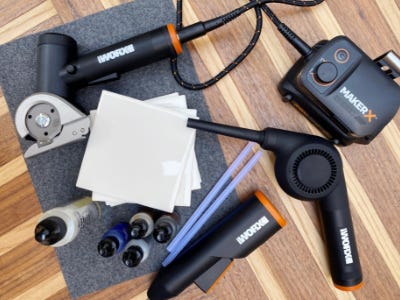 zipsnip, mini blow gun, and glue gun next to paint colors and blank coasters