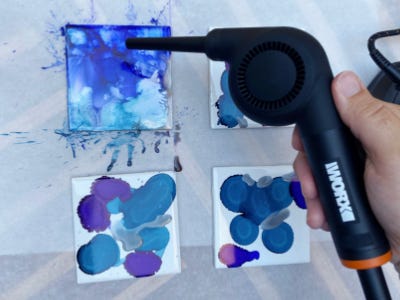 holding mini blow gun blowing around splatter spots