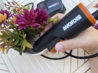 glueing the cardboard with flowers into pot