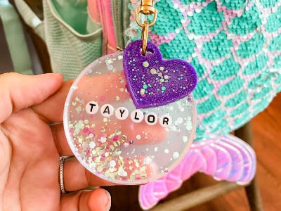 resin bag tag with Taylor name and purple heart on backpack