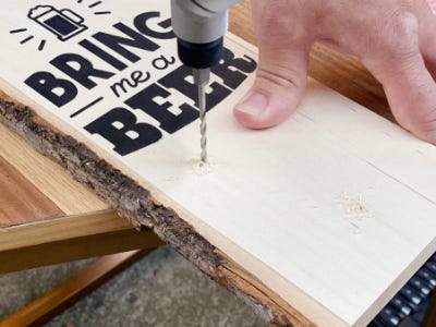 drill hole into bottom of the wood with painted words on it