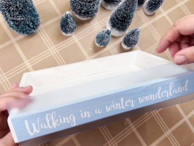 adding stencil waling in a winter wonderland to side of box