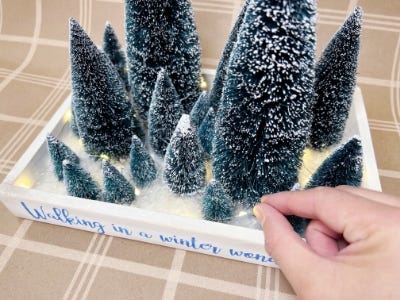 adding lights into christmas tree tray