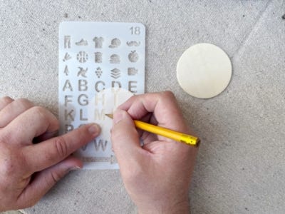 tracing stencils on to blank wood circle