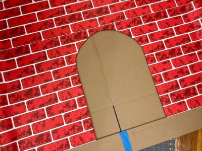 front of fireplace cardboard cutout with round door