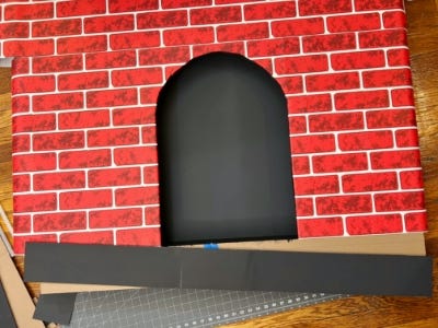 adding black base cardboard to bottom of fireplace cutout