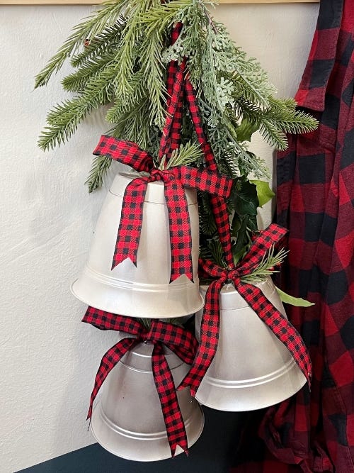 DIY holiday bells tied with ribbon and greenery