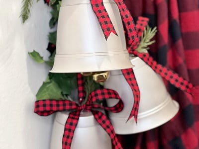 close shot of three silver red and black plaid ribbons hanging on wall