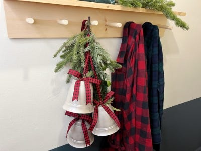 close shot of three silver red and black plaid ribbons hanging next to jacket hanger