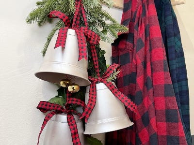 close shot of three silver red and black plaid ribbons hanging next to jacket hanger and 2 jackets