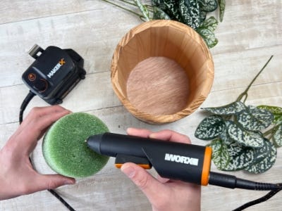 person applying glue to the plant foam