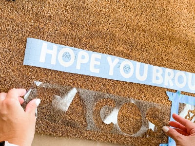 Laying down tacos stencil onto doormat