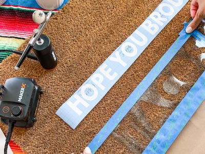 Continue using painters tape tape around tacos stencil onto doormat