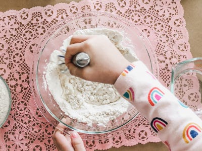 Hand stirring flour and water in blowl