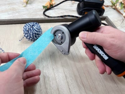 image of a person using the rotary cutter to cut felt