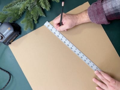 using pencil to mark guidelines on cardboard with ruler