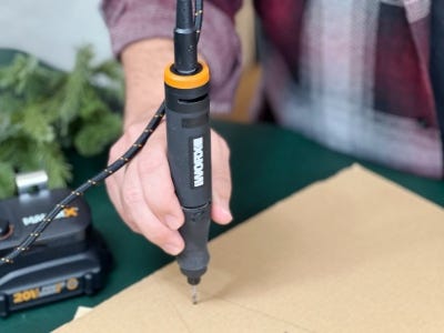 using the worx rotary tool to drill holes in cardboard