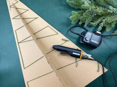 mini glue gun laying on top of cardboard box