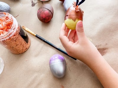 yellow egg being painted brown