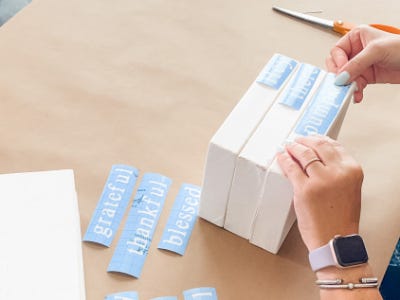 placing cut out stencils onto three stacked wood pieces 