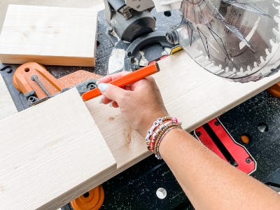 measuring pencil drawing on edge next to saw