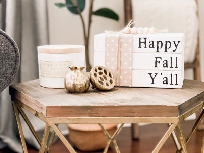 faux stacked books with happy fall yall on table