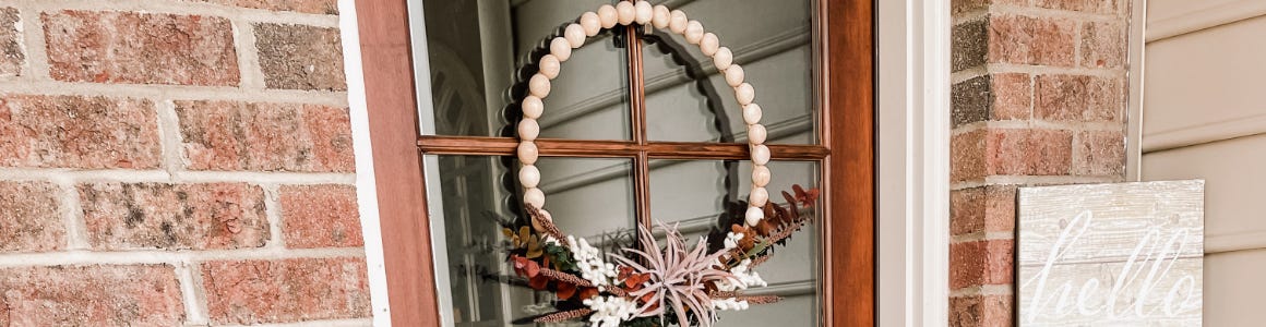 fall wreath media hanging on glass door 