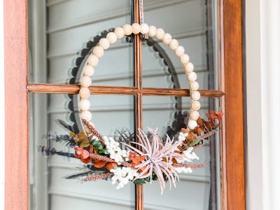 finished wooden wreath frame on glass door