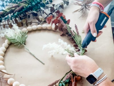 using mini glue gun to glue greenery 