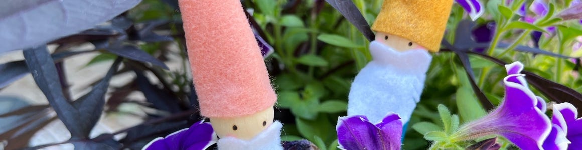 mini gnome garden stakes in grass
