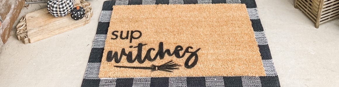 sup witches halloween doormat in front of door