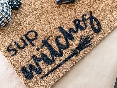 Sup witches painted on text to doormat