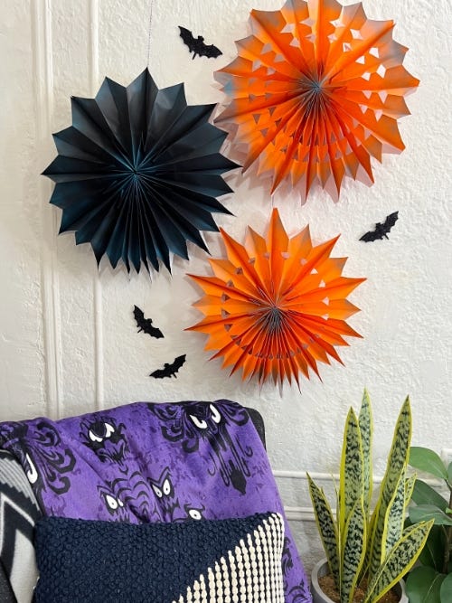 orange and black pinwheels attached to the wall