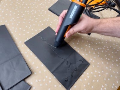 Hot glue gun glueing tissue paper 