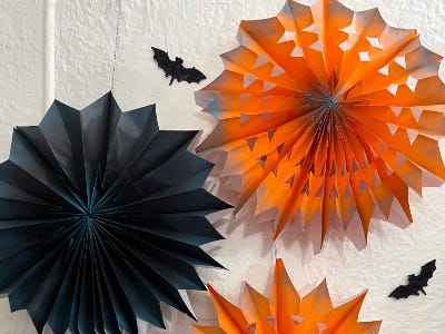 Orange and black pinwheels and two bats