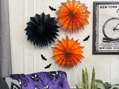 Orange and black pinwheels and four bats and purble throw over