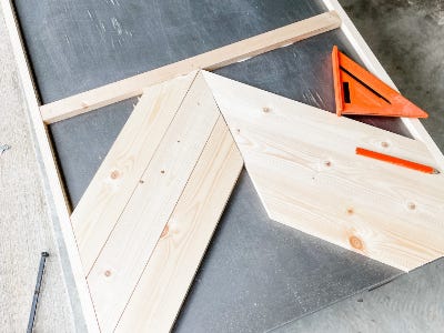 two angled cut wood piece being placed together