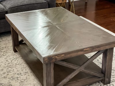 dried herringbone table on top of carpet next to couch