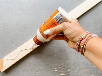 adding glue to top of wood piece