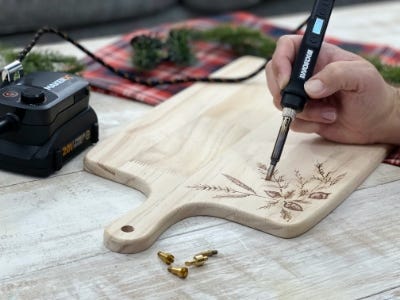 using wood burning gift to burn leafs into wood plate with battery and charger