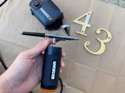 holding air brush above 4 and 3 numbers