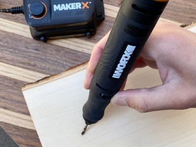 using drill bit with rotary tool into wood piece