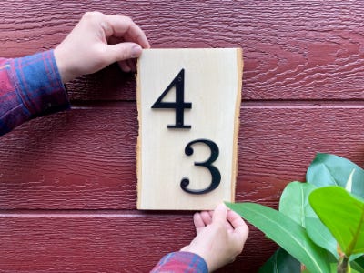 hanging 43 house number on wood piece 