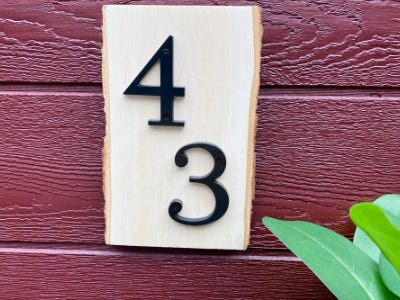 hung 43 house number on wood piece 