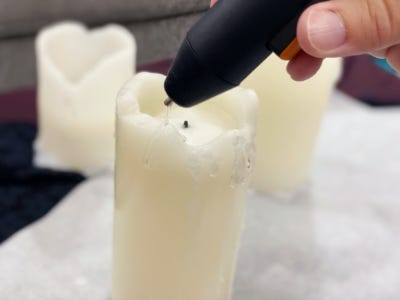 using glue gun to reform the back of the melted candle