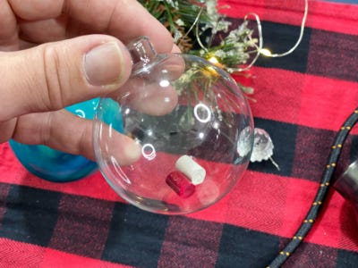 holding clear ornament 