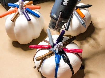 using heat gun to melt crayons on top of white pumpkin