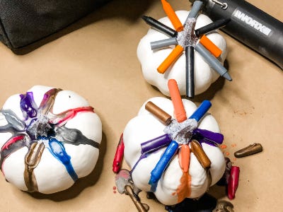 3 white pumpkins with dripping melted crayons on top