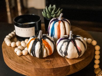 dried melted crayon pumpkins on wood stand