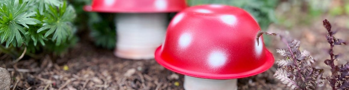 Metal mushrooms sitting in dirt